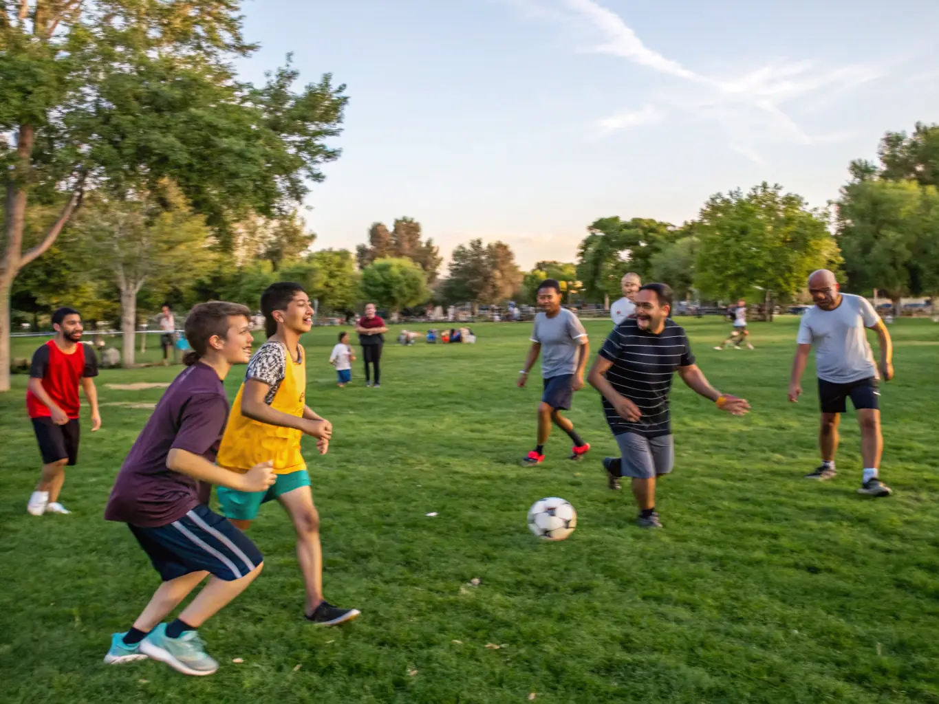 A diverse group of adults participating in a community sports league game, highlighting the camaraderie and competitive spirit of our adult programs.